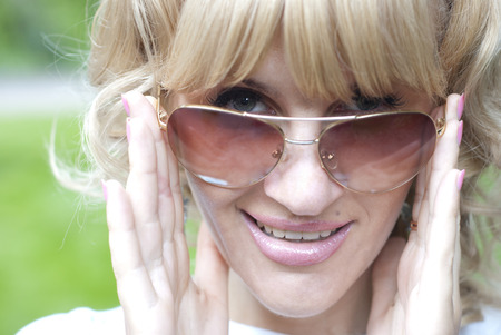smiling young lady wearing sunglassesの写真素材