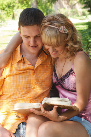 couple sitting on a park benchの写真素材