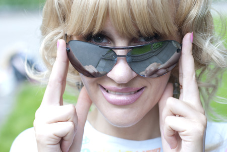 smiling young lady wearing sunglassesの写真素材