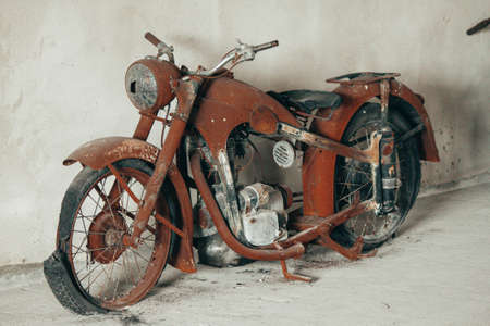 Vintage fully rusty motorcycle with torn tires