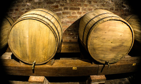 Two large vintage wooden barrels with taps in a wine cellar