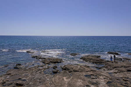 Small shallow sea creek with stones under the sunの写真素材