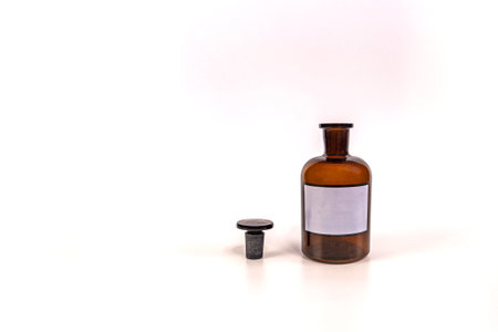 Brown medical jar with a glass stopper on a white background with a labelの写真素材