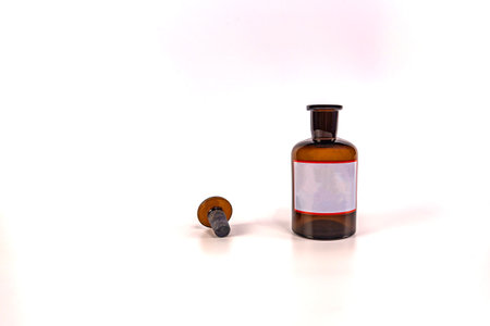 Brown medical jar with a glass stopper on a white background with a labelの写真素材