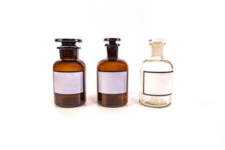 Three medical jars with glass stoppers on a white backgroundの写真素材