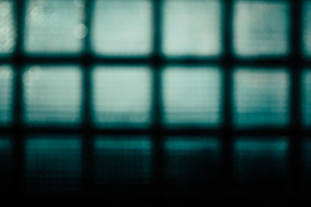Green abstract blurred background. The wall of glass blocks