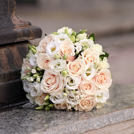 Bridal bouquet of roses on a granite parapetの写真素材