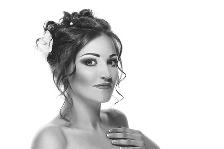 Portrait of a beautiful girl in the image of a bride with a white flower in her hair - isolated on white background. Black and white photographyの写真素材