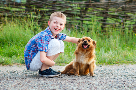 nice smiling boy with a smiling dog.Best friends. Outdoorの写真素材