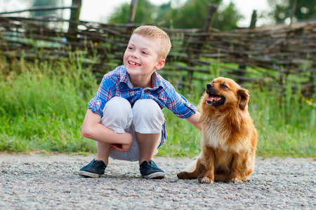 nice smiling boy with a smiling dog.Best friends. Outdoorの写真素材