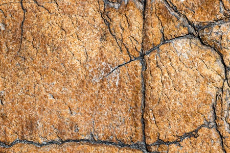 texture of brown stone or marble with vertical and horizontal cracksの写真素材