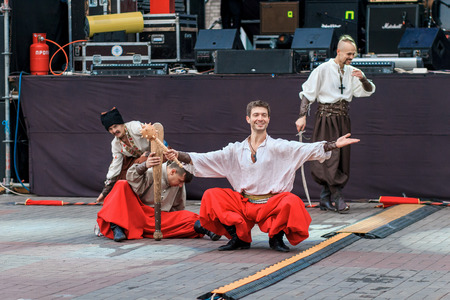Dneprodzerzhinsk, Ukraine - October 15, 2016: theatrical performance of Ukrainian cossacks, dances and elements of combat with sabersのeditorial素材