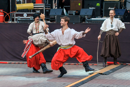Dneprodzerzhinsk, Ukraine - October 15, 2016: theatrical performance of Ukrainian cossacks, dances and elements of combat with sabersのeditorial素材