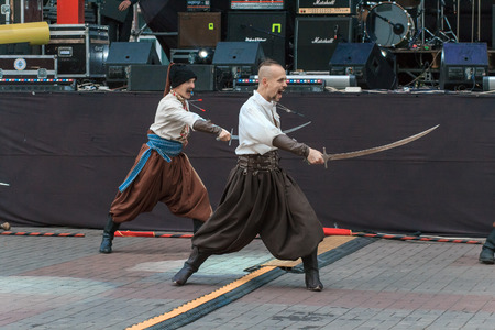 Dneprodzerzhinsk, Ukraine - October 15, 2016: theatrical performance of Ukrainian cossacks, dances and elements of combat with sabersのeditorial素材