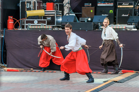 Dneprodzerzhinsk, Ukraine - October 15, 2016: theatrical performance of Ukrainian cossacks, dances and elements of combat with sabersのeditorial素材