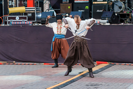 Dneprodzerzhinsk, Ukraine - October 15, 2016: theatrical performance of Ukrainian cossacks, dances and elements of combat with sabersのeditorial素材