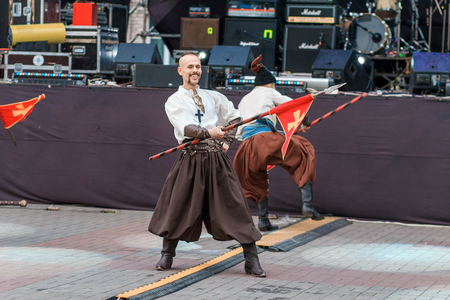Dneprodzerzhinsk, Ukraine - October 15, 2016: theatrical performance of Ukrainian cossacks, dances and elements of combat with sabersのeditorial素材