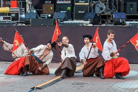 Dneprodzerzhinsk, Ukraine - October 15, 2016: theatrical performance of Ukrainian cossacks, dances and elements of combat with sabersのeditorial素材