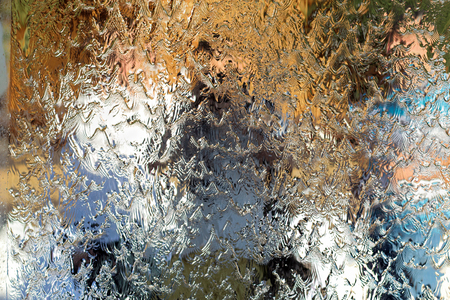 Water flows along the wall of the mirror, horizontal abstract texture, shiny backgroundの写真素材