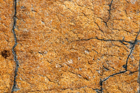texture of brown stone or marble with vertical and horizontal cracksの写真素材
