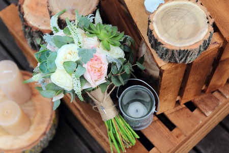 Bridal bouquet of roses on a wooden planksの写真素材