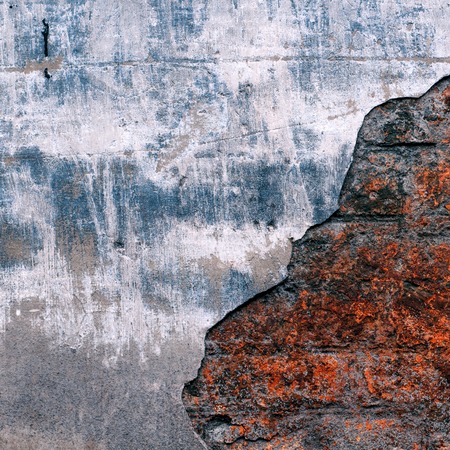 Old brick wall with remains of plasterの写真素材