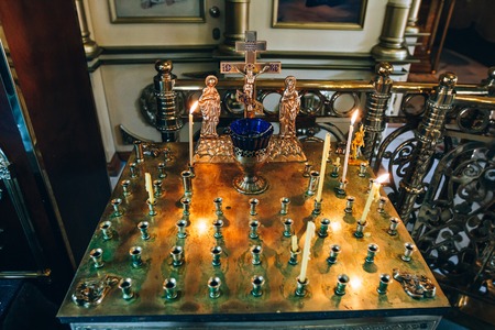 golden candleholder in church, stand for candles in the interior of orthodox church, orthodox icon...
