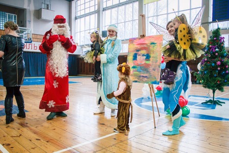Kamenskoye, Ukraine - December 26, 2016: Christmas party for federation of cheerleading in Kamenskoye, Father Frost plays with children and leads a round danceのeditorial素材