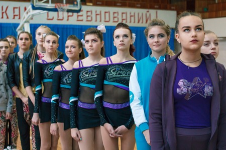 Kamenskoye, Ukraine - November 28, 2017: young athletes listen to the national anthem, championship of the city of Kamenskoye in cheerleading among solos, duets and teamsのeditorial素材