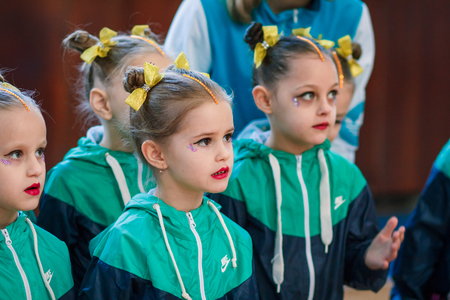 Kamenskoye, Ukraine - November 29, 2017: young athletes listen to the national anthem, ?hampionship of the city of Kamenskoye in cheerleading among solos, duets and teamsのeditorial素材