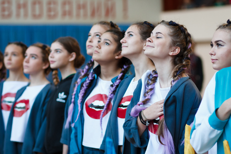 Kamenskoye, Ukraine - November 29, 2017: young athletes listen to the national anthem, Ñhampionship of the city of Kamenskoye in cheerleading among solos, duets and teamsのeditorial素材
