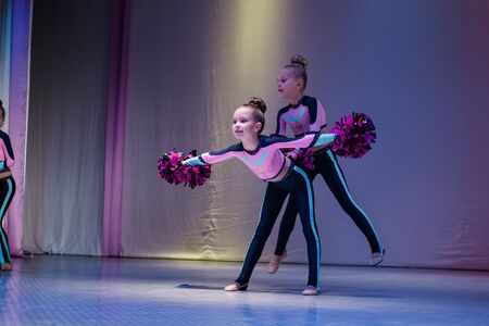 Kamenskoye, Ukraine - October 14, 2018: Championship of the city of Kamenskoye in cheerleading among duets and teams, young cheerleaders perform at the city cheerleading championshipのeditorial素材