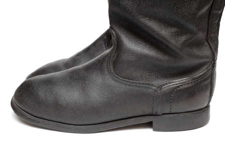 Side view of old military boots made of leather on white background, black army boots isolated on white, combat and ceremonial shoes of a soldier of the army of the Soviet Unionの写真素材