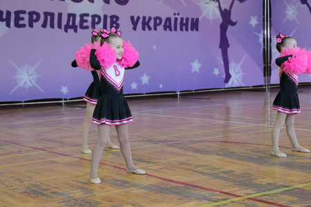 Kamianske, Ukraine - March 21, 2021: Cup of Dnipropetrovsk region, cheerleaders perform at the championship, Youth Pom, team performance, concept of action, team sport, energy, vitality, childhoodの写真素材