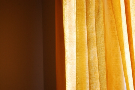 Sun shining through the curtainの写真素材