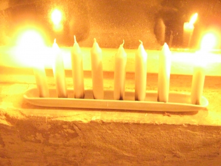 Hanukkah lights are reflected in a frozen windowの写真素材