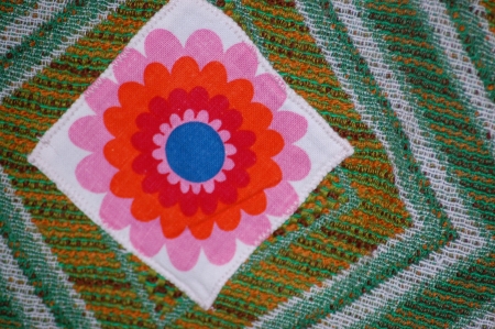 Patchwork with red flower on green background