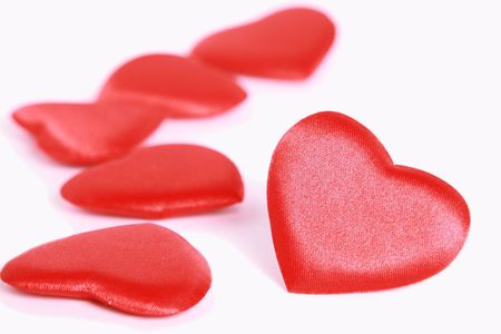 Red shiny hearts isolated on whiteの写真素材