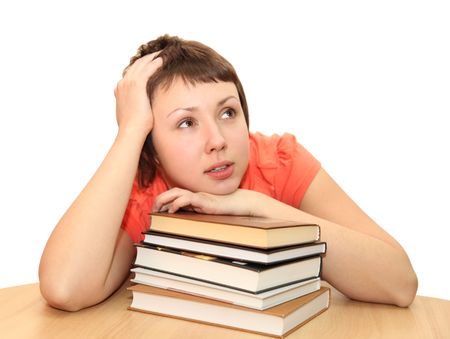 Young woman dreaming with books, isolated on whiteの写真素材