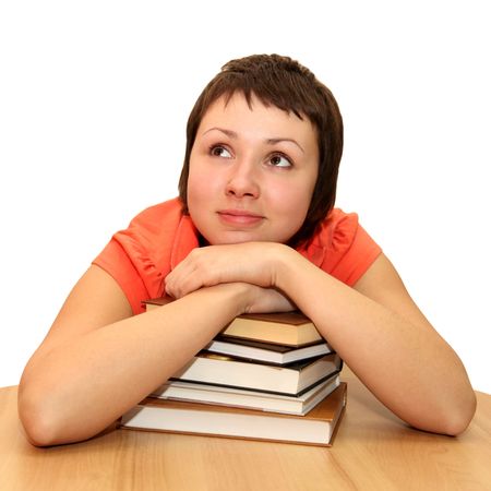 Young woman dreaming with books, isolated on whiteの写真素材
