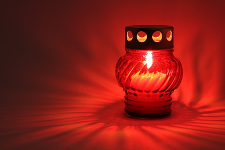 Memory lantern with burning candle in the dark