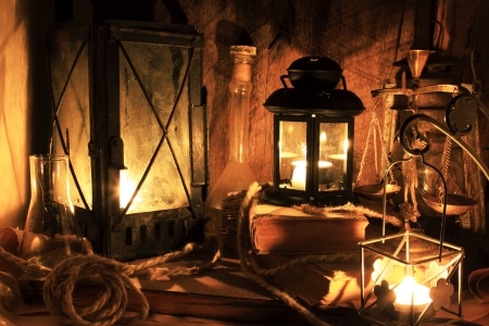 Still life with old things - old lamps, books on wooden backgroundの写真素材