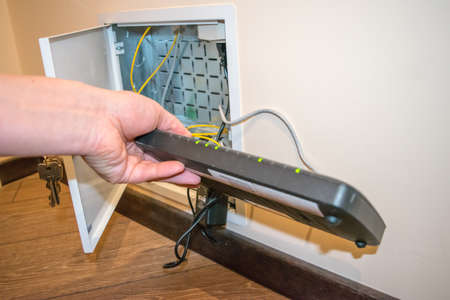 Open box to router, human hand human hand is holding black router