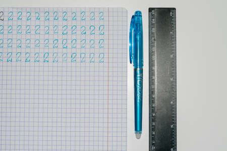 View of a notebook with numbers entered, next to it are a pen and a ruler