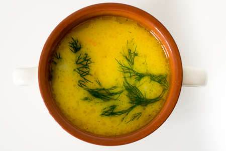 A cup of cheese soup with rusks