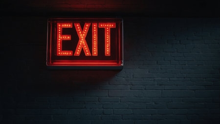 A sign with the word EXIT on a dark backgroundの素材