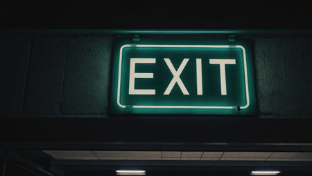 A sign with the word EXIT on a dark backgroundの素材
