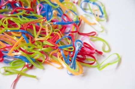 Colorful rubber bands on white background