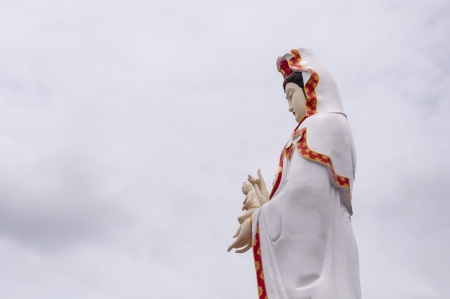 The Guan Yin Buddha Statue postures of giving alms childの写真素材