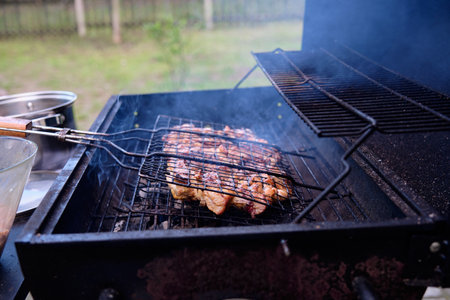 Cooking meat on the grill on the coals on the barbecue.